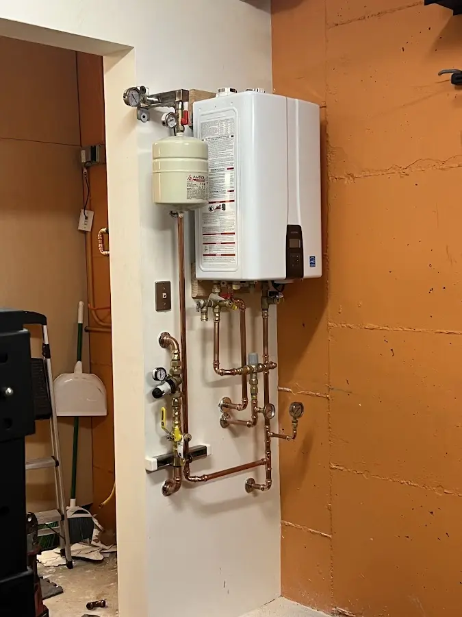 Plumbing technician inspecting water heater connections in Pleasant Hill
